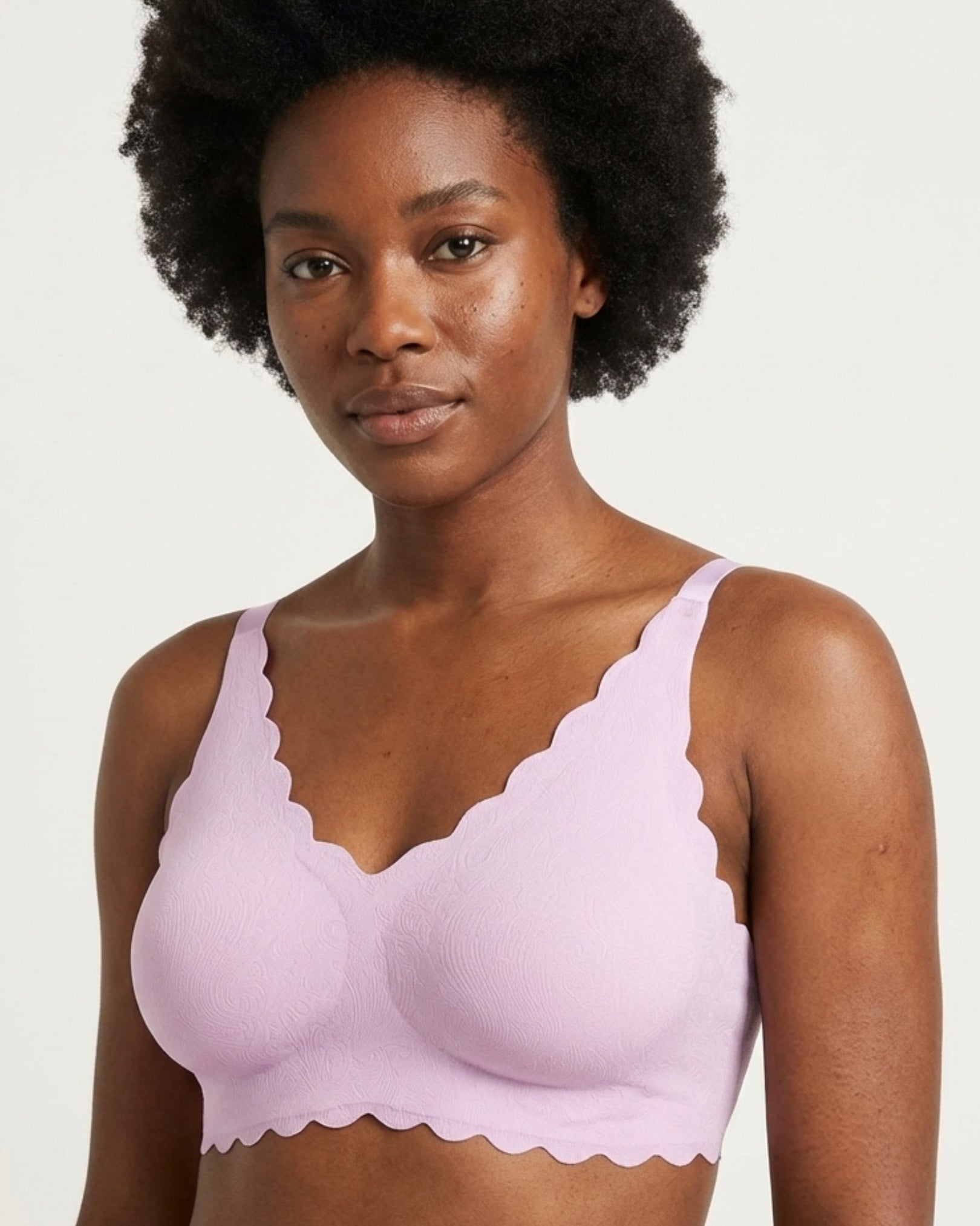 Woman wearing a light purple Invisible Edge w/ animal print against a plain background