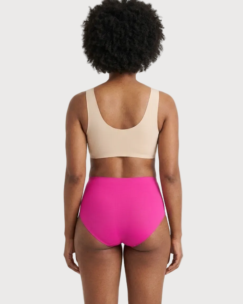 Backside of a woman wearing pink Invisible Edge Scalloped Briefs against a plain background