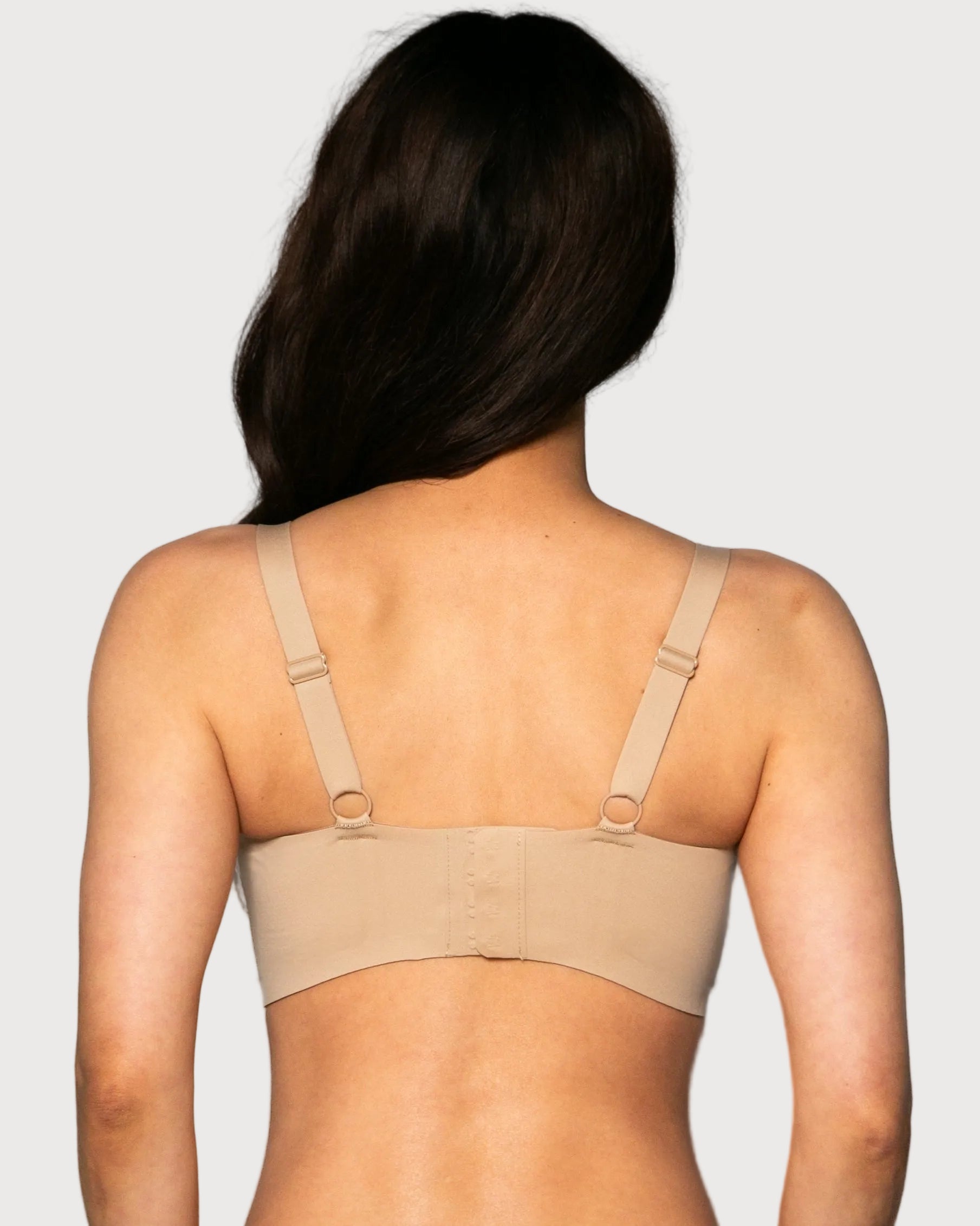 Back view of a woman wearing a beige Gel Bra with Lace Detail and Back Closure bra against a gray background