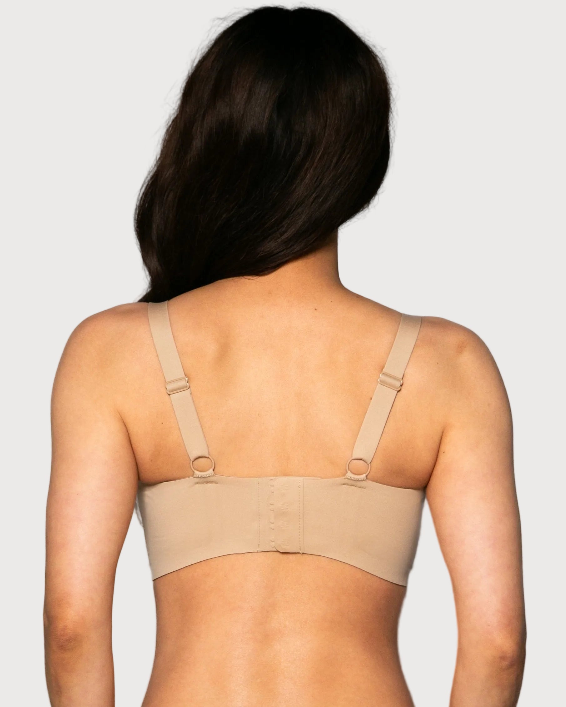 Back view of a woman wearing a beige Gel Bra with Lace Detail and Back Closure bra against a gray background