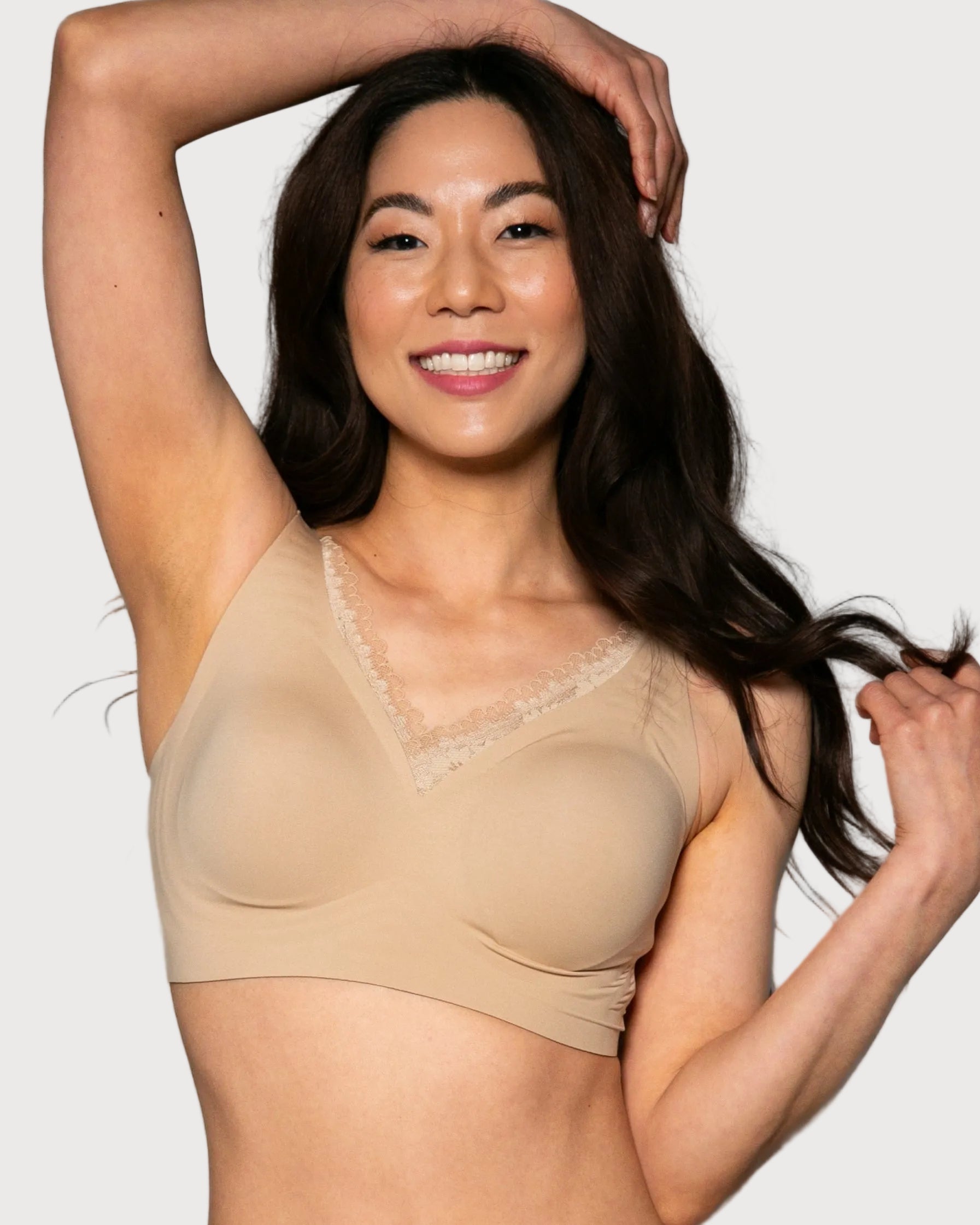 Woman wearing a beige Gel Bra with Lace Detail and Back Closure bra against a gray background