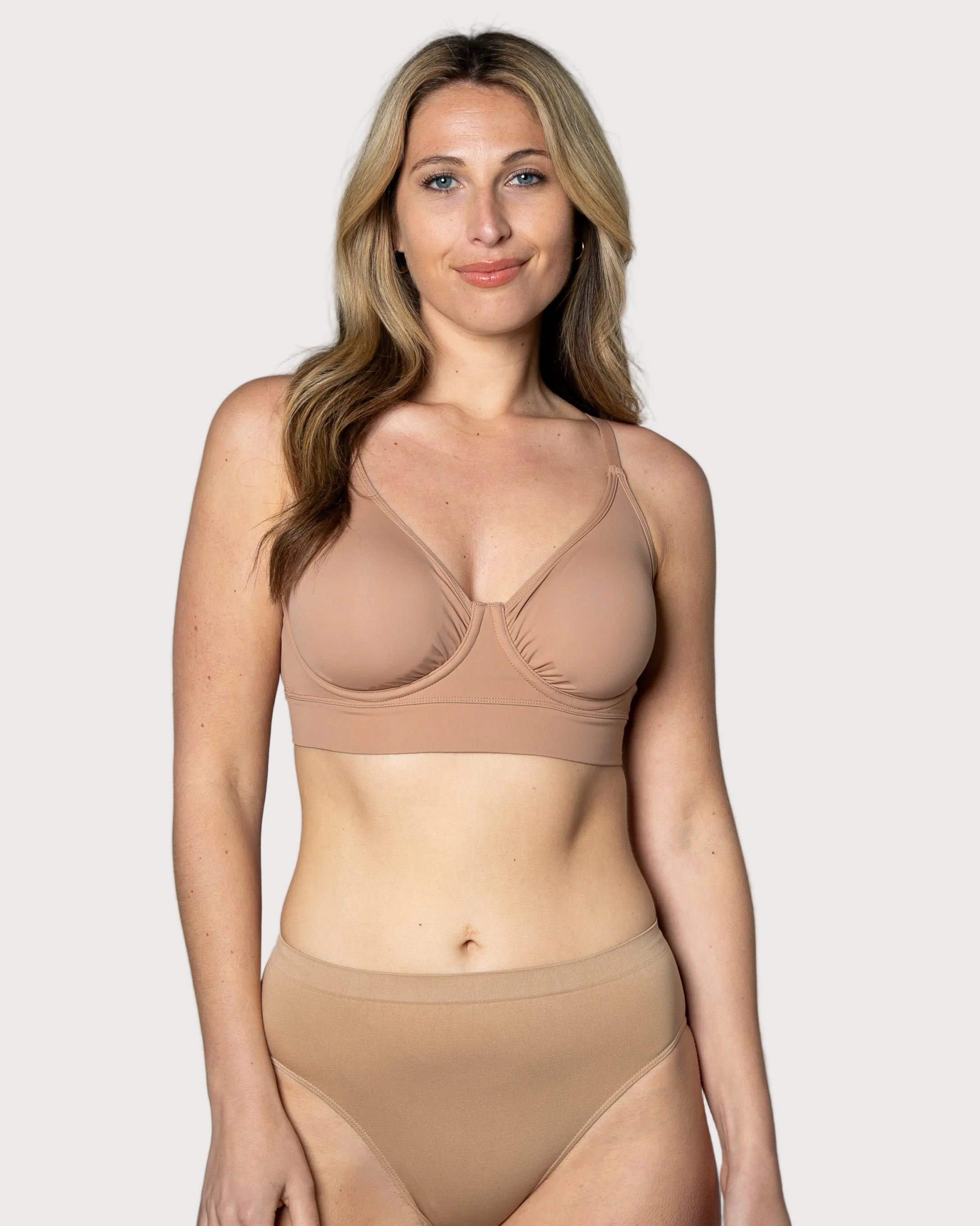 Woman wearing a beige No Wire Underwire bra and panties set against a gray background