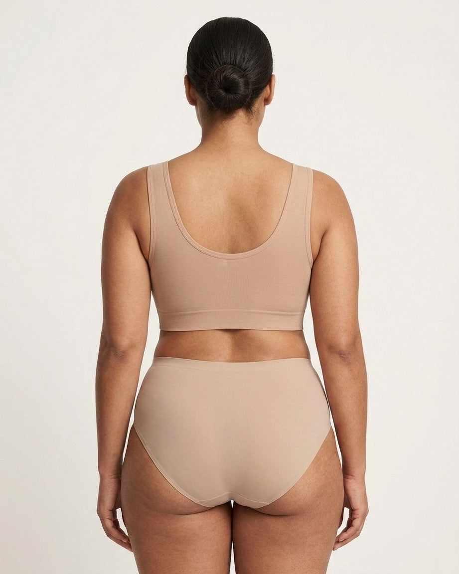 A model shown from the back wearing a beige Mesh Front Leisure Bra, against a plain light background.