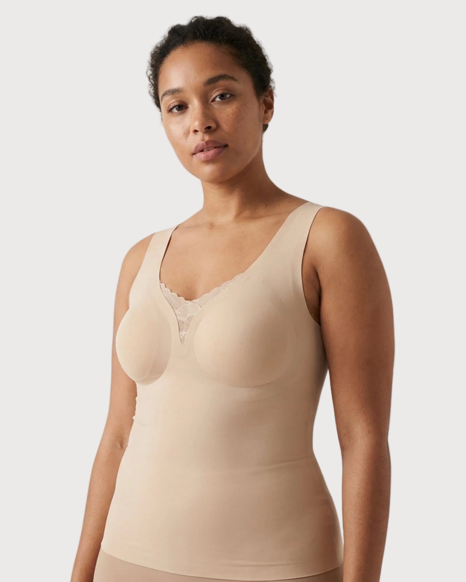 Woman wearing a beige Butterknit Tank with Lace Inset against a plain background