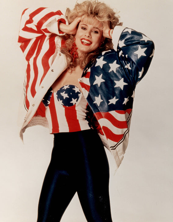 Rhonda Shear wearing an American flag jacket on a plain background