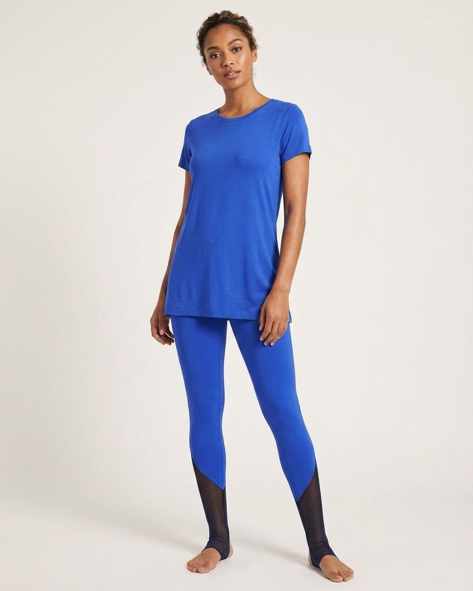 Woman wearing a blue athletic outfit on a white background