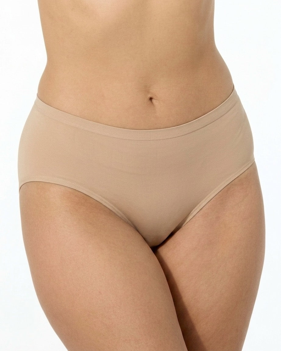 A close-up of a model wearing Seamless Lightweight Brief in a light beige shade against a plain white background.