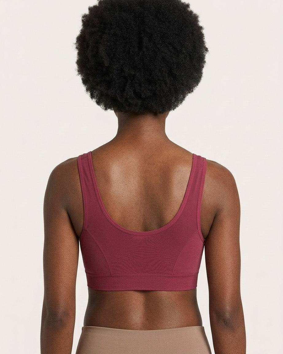 Rear view of a model wearing a beet Mesh Front Leisure Bra and beige bottoms, set against a plain light beige background.