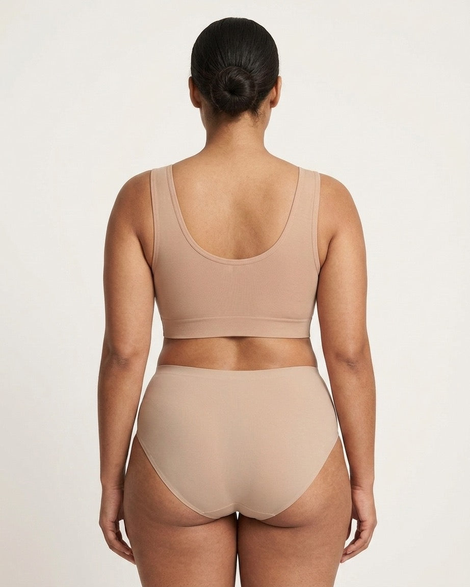 A model shown from the back wearing a beige Mesh Front Leisure Bra, against a plain light background.