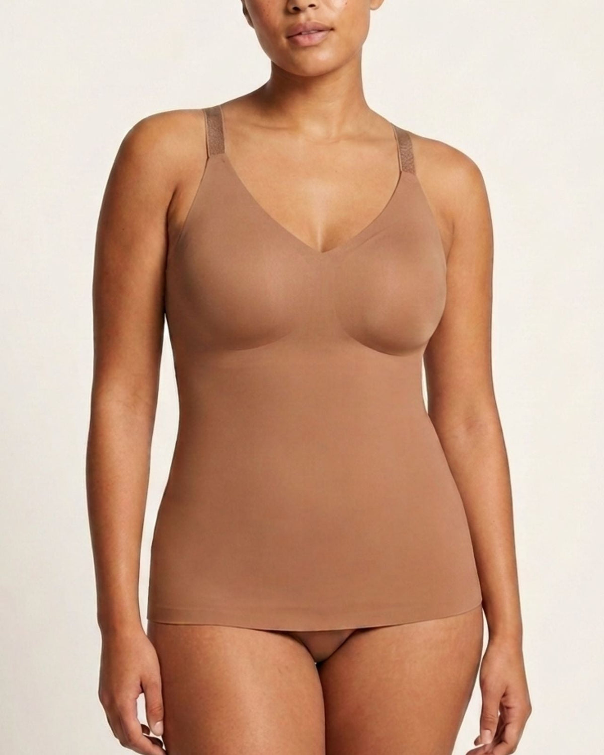 A woman modeling a mahogony Adjustable Strap Butterknit Tankagainst a plain light background.
