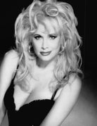 Black and white portrait of Rhonda Shear with styled hair against a neutral background